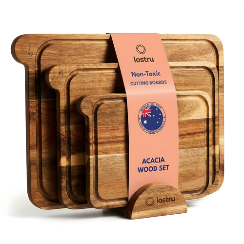 Set of wooden cutting boards with a Lostru branded strap on a white background