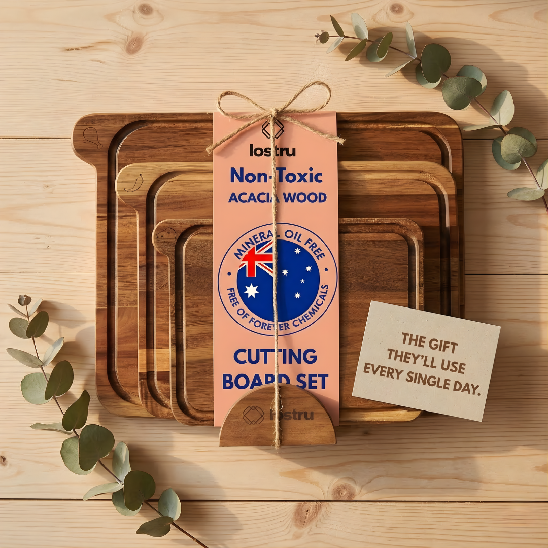 Set of wooden cutting boards with a packaging tag on a wooden surface