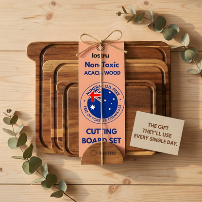 Set of wooden cutting boards with a packaging tag on a wooden surface